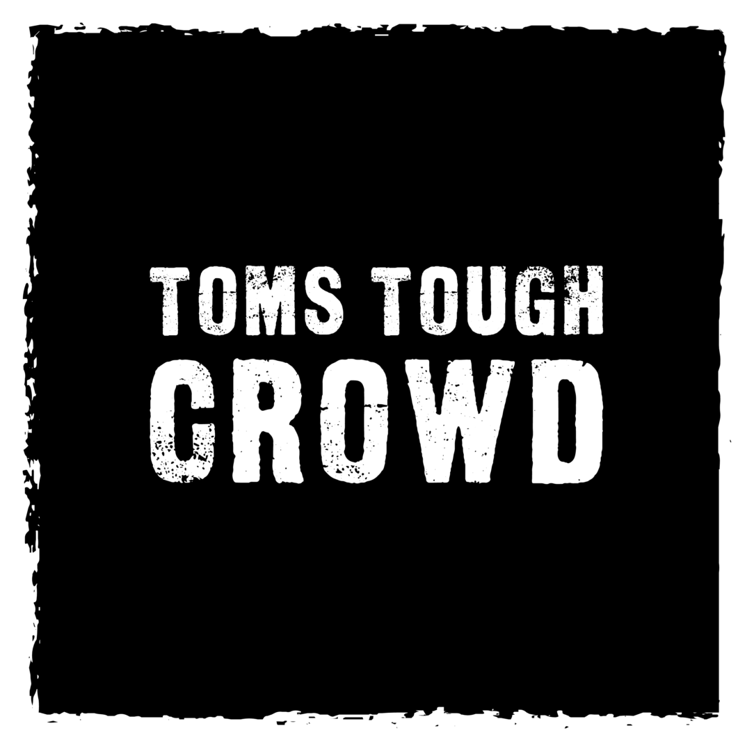 A black and white photo of the words toms tough crowd.