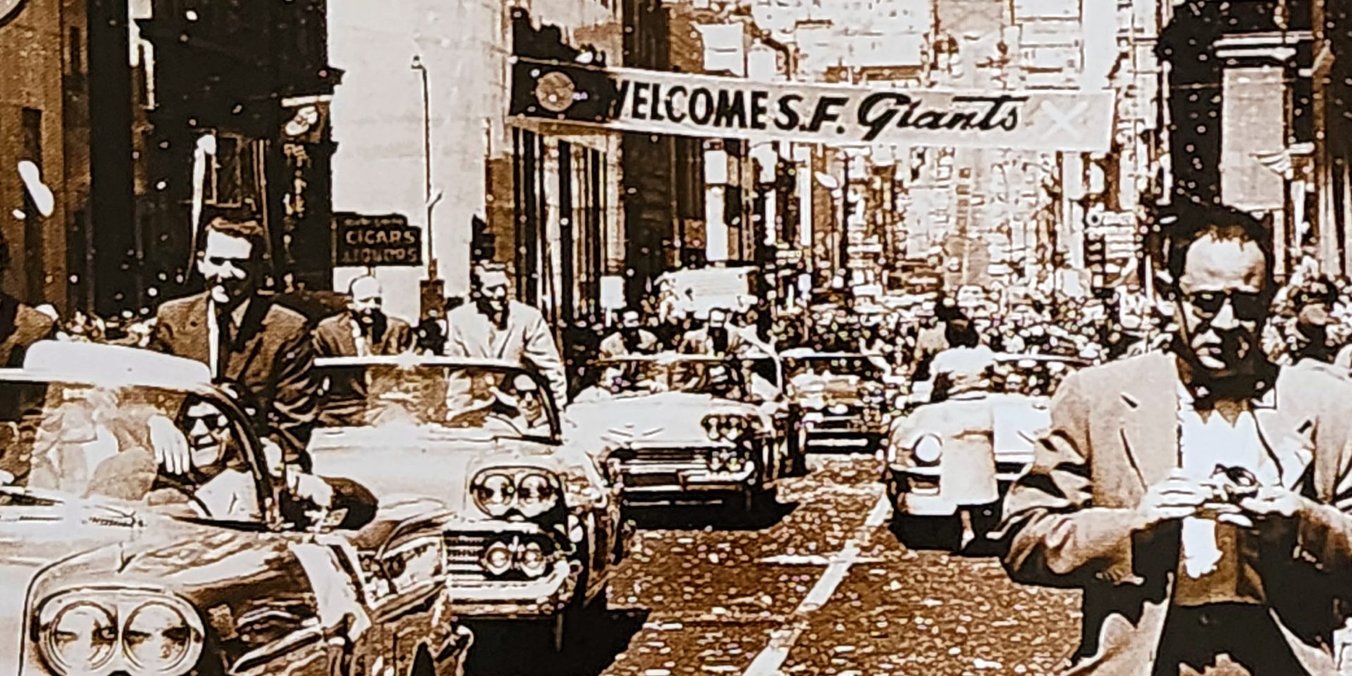 A vintage photo of cars driving down the street