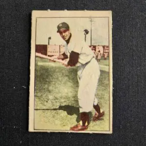 A baseball player is holding his bat in the air.