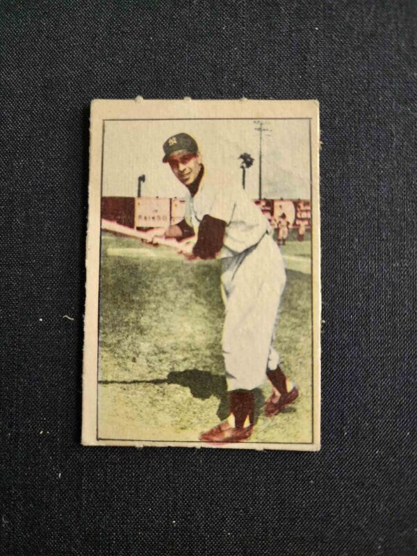 A baseball player is holding his bat in the air.