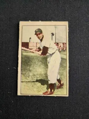 A baseball player is holding his bat in the air.