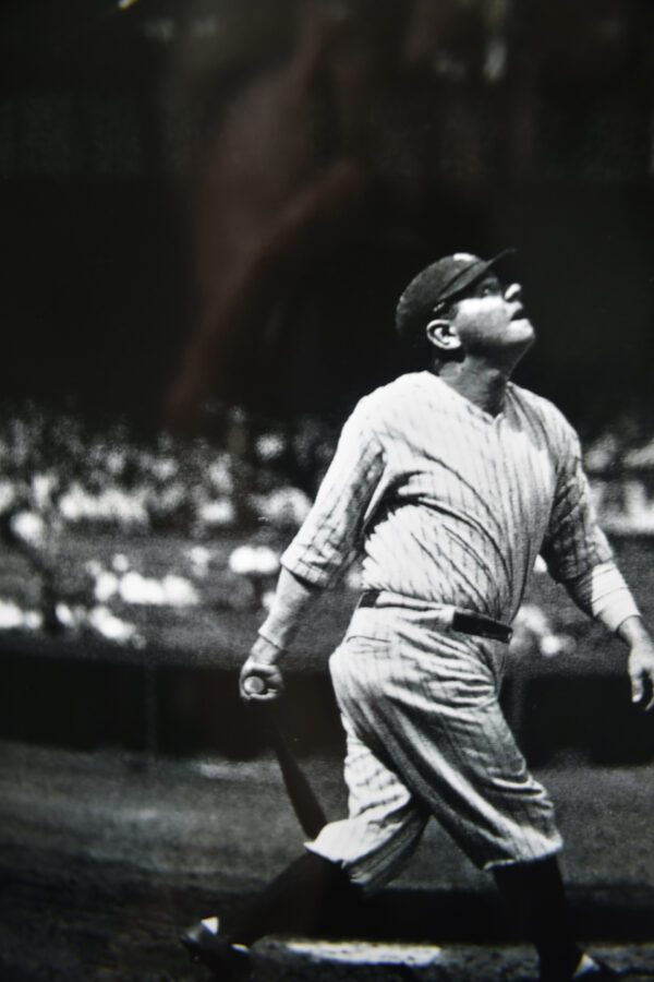 A baseball player is standing in the outfield.