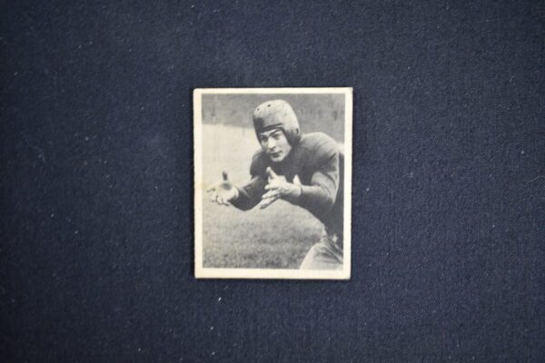 A black and white photo of an old football player.