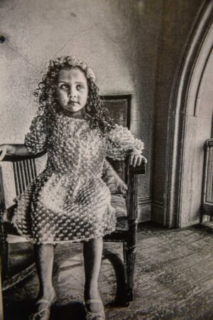 A young girl sitting in a rocking chair.