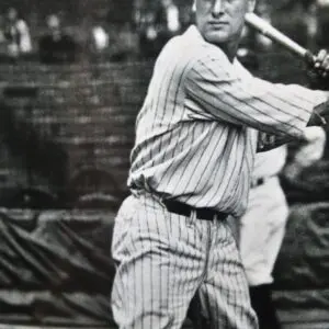 A man swinging a baseball bat at a game.