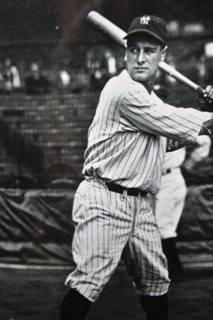 A man swinging a baseball bat at a game.