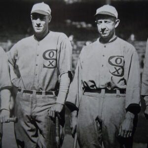 Two baseball players standing next to each other.