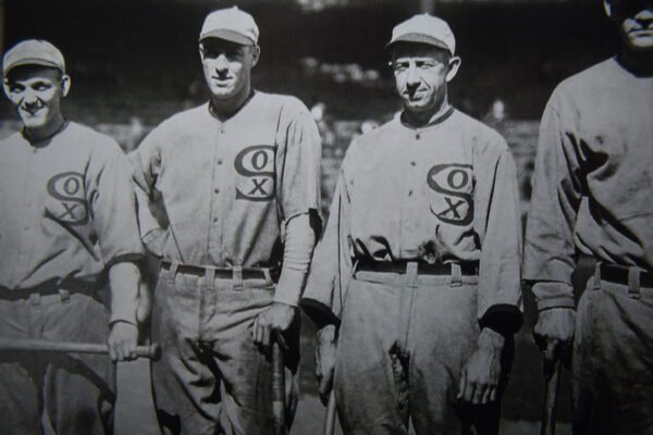 Two baseball players standing next to each other.