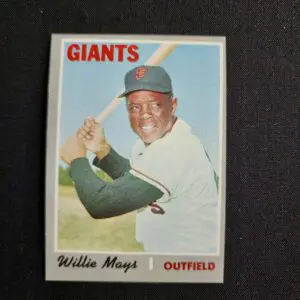 A baseball card of willie mays with the giants logo.