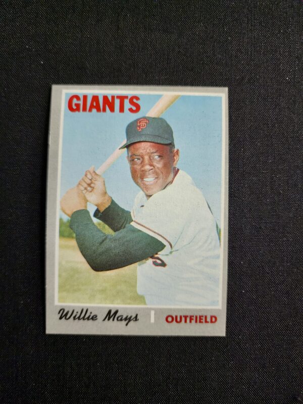 A baseball card of willie mays with the giants logo.