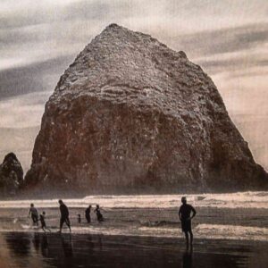 A group of people standing on top of the beach.