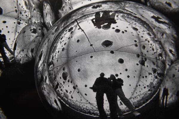 Two people are standing inside a bubble.