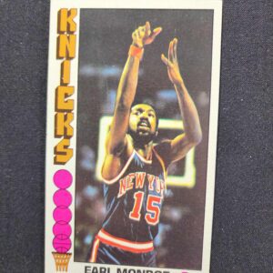 A card of earl monroe with his hands raised.