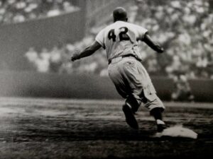 A baseball player running to the plate during a game.