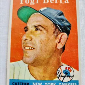 A baseball card of yogi berra is shown.