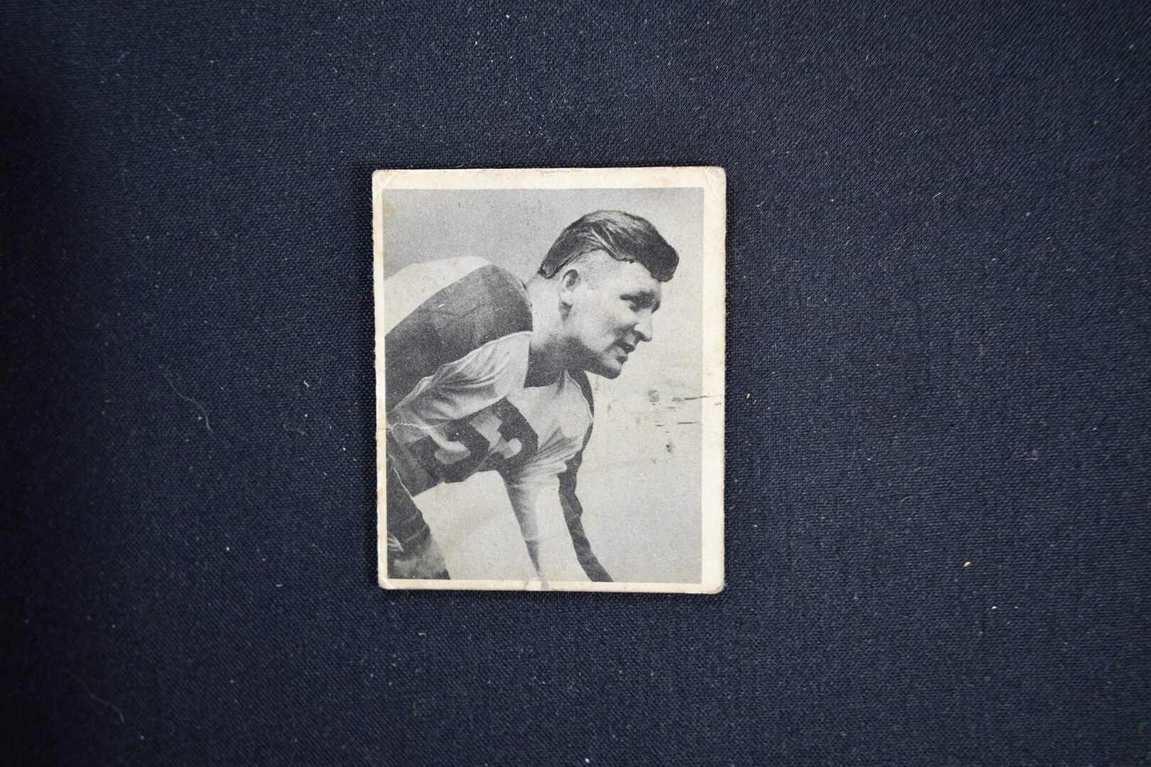 A black and white photo of a man in striped shirt.