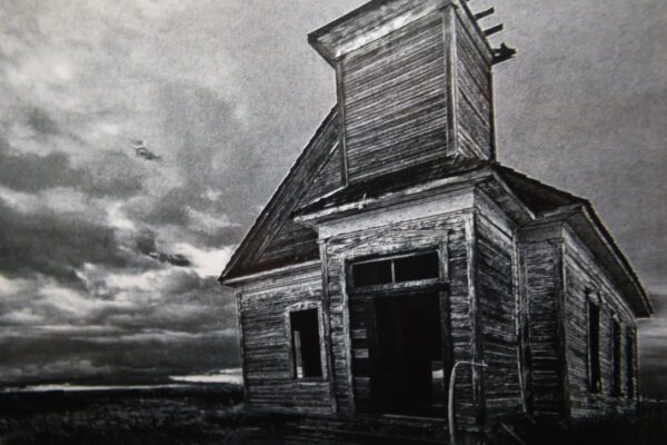 A black and white photo of an old church.