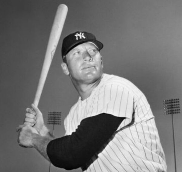 A baseball player holding a bat in his hands.