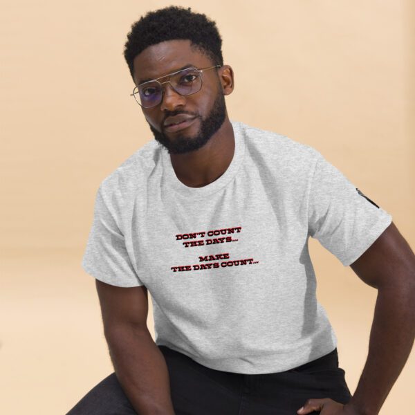 A man sitting on the ground wearing glasses.