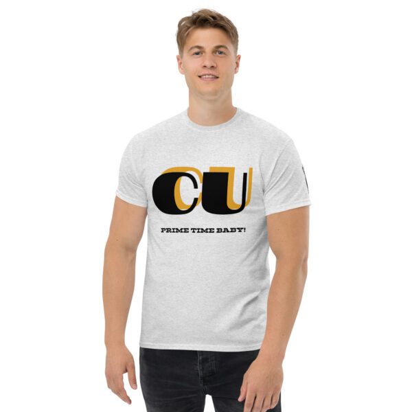 A man wearing a white t-shirt with the letters cu in black and yellow.