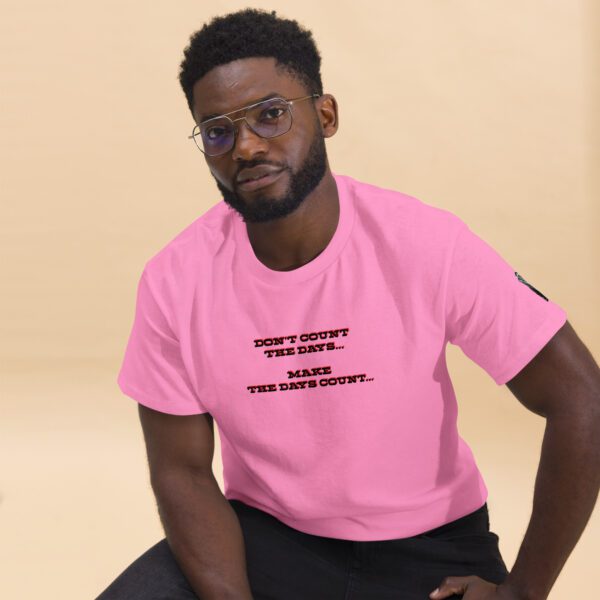 A man in pink shirt sitting on the ground.