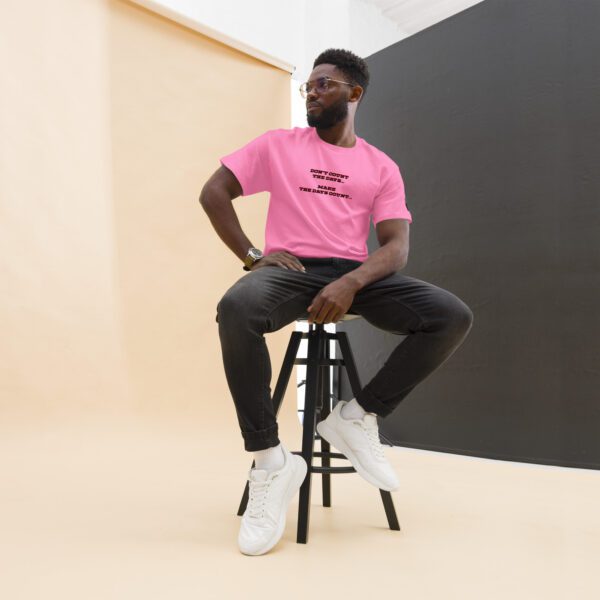 A man sitting on top of a stool wearing white shoes.