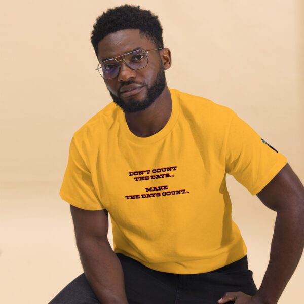 A man in yellow shirt sitting on the ground.