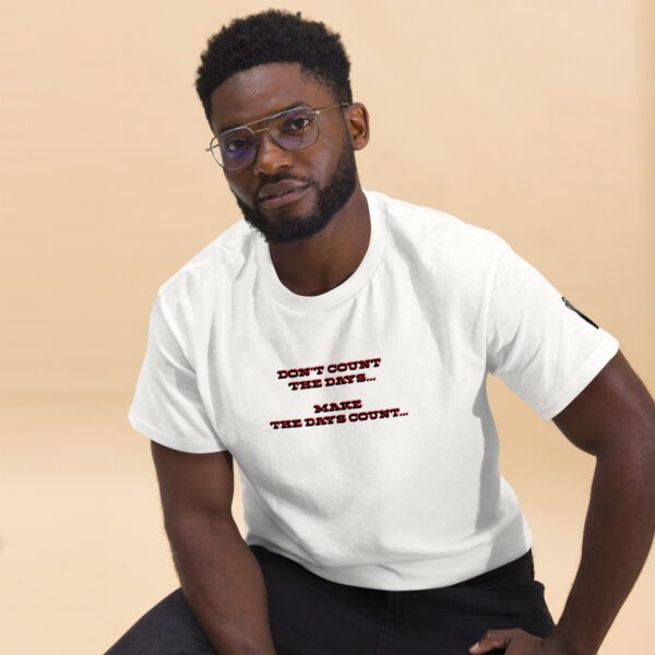 A man in white shirt sitting on the ground.