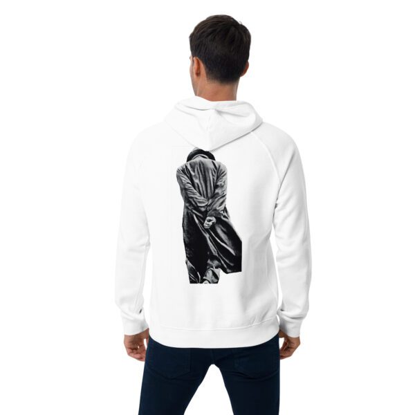 A man wearing a white hoodie with an image of a person on it.