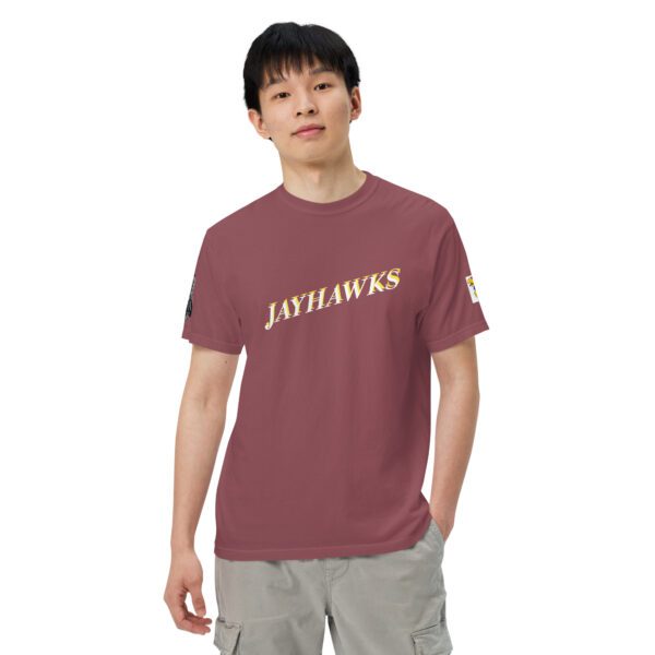 A man wearing a maroon shirt with the words " jayhawks ".