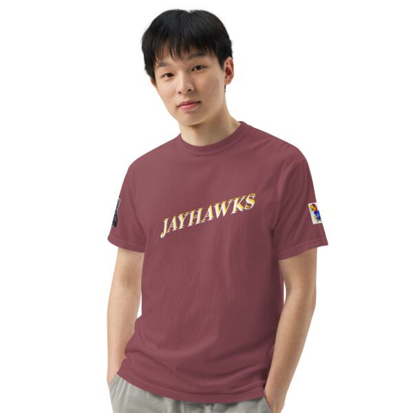 A man wearing a maroon shirt with the jayhawks on it.