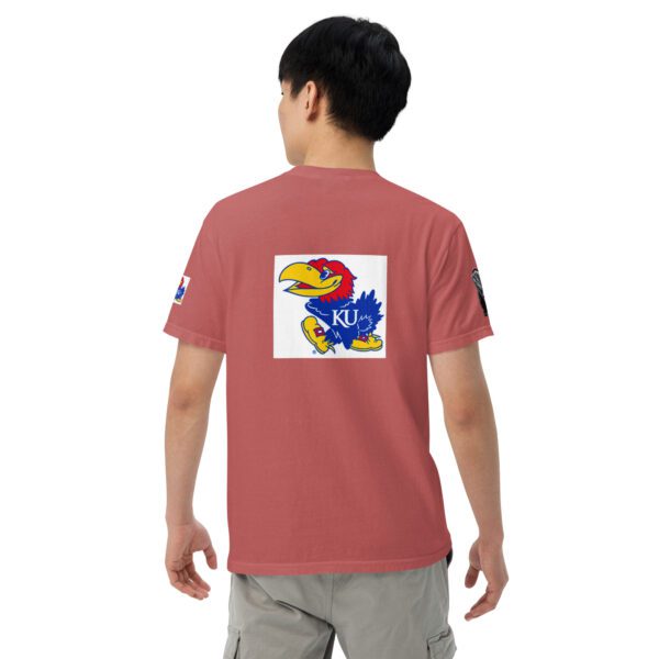 A person wearing an orange shirt with a blue and yellow bird on it.