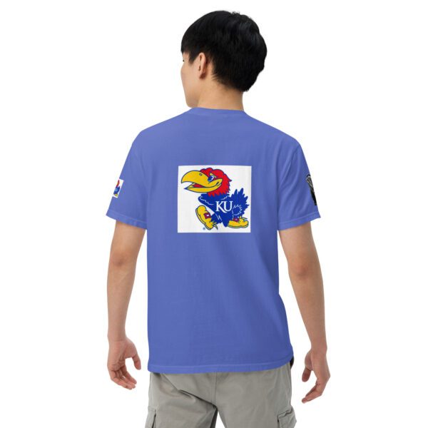 A person wearing a blue shirt with a picture of the kansas jayhawks on it.