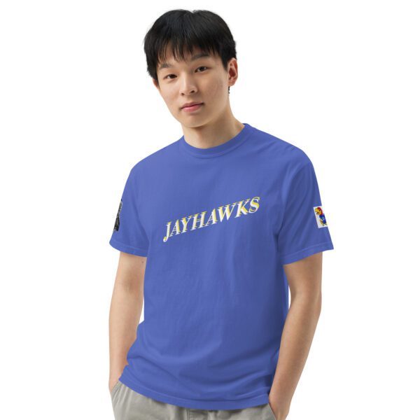 A man wearing a blue shirt with the jayhawks logo on it.