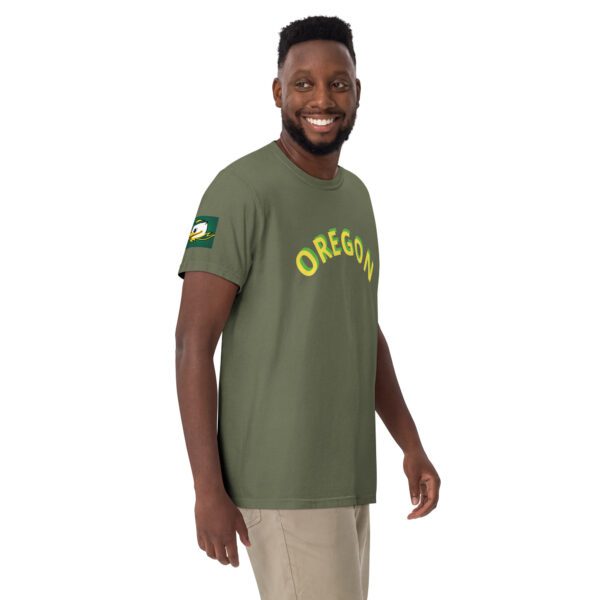 A man wearing an oregon shirt and smiling.