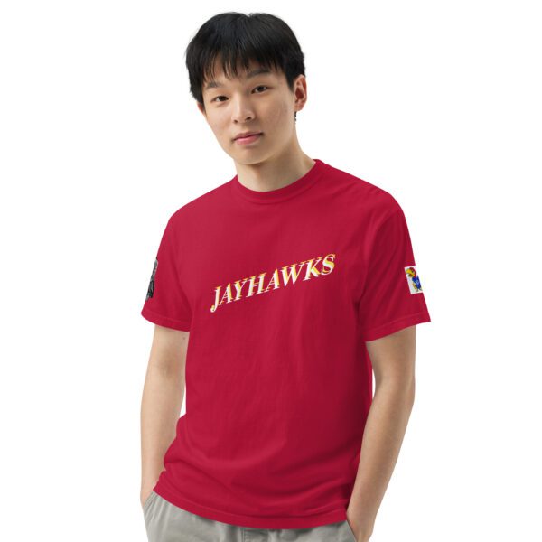 A man wearing a red shirt with the jayhawks on it.