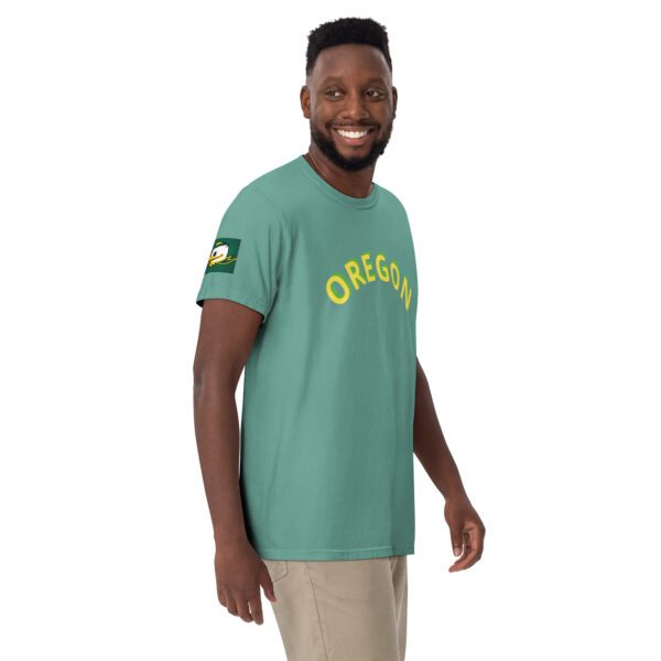 A man wearing an oregon shirt and smiling.