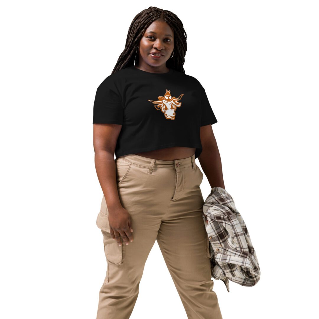 A woman standing in front of a white wall.