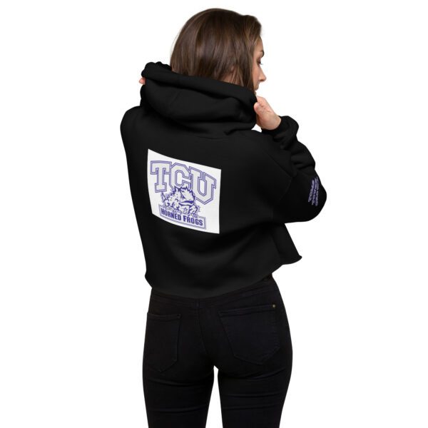 A woman wearing a black hoodie with a patch on the back.