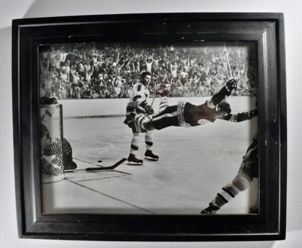 Black and white photo of hockey players in action.