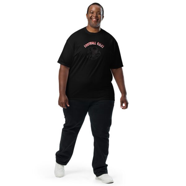 A man standing in front of the camera wearing black pants and a t-shirt.