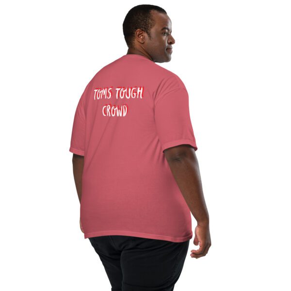 A man wearing a pink shirt with the words " don 't touch this ".