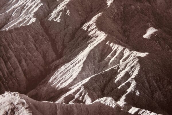 Arid mountain range with eroded slopes.