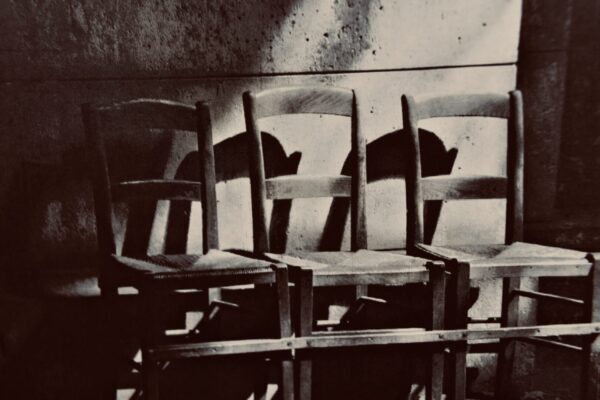 Three wooden chairs in a row.