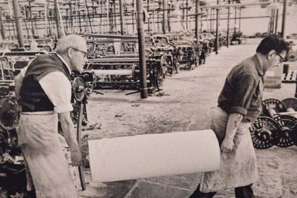 Two men working in textile factory.