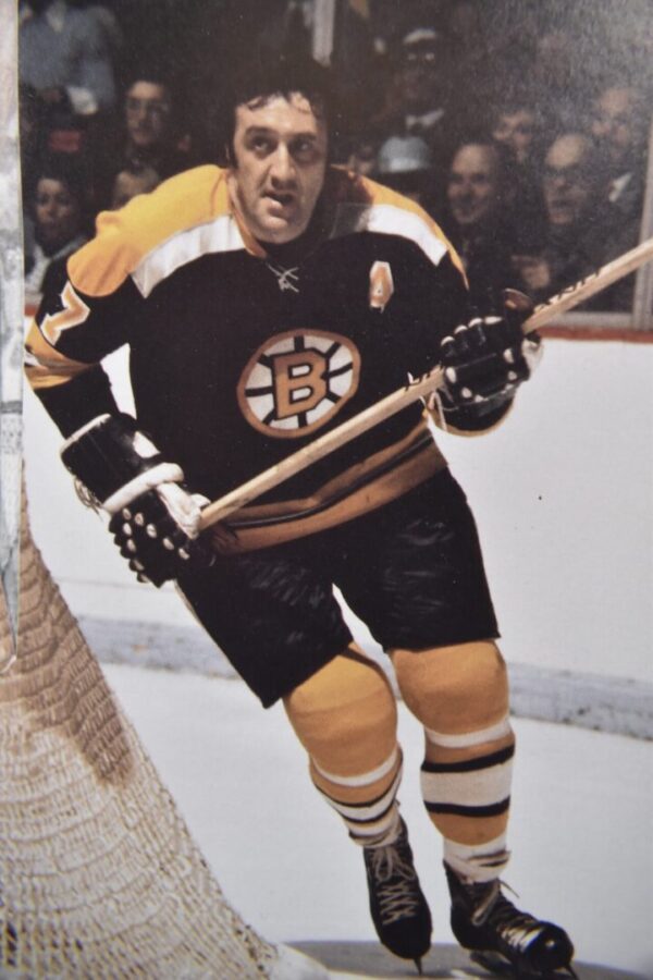 Boston Bruins hockey player skating with puck.