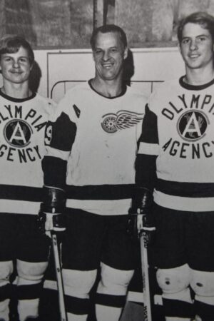 Three hockey players in black and white.