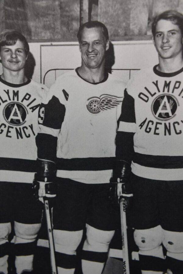 Three hockey players in black and white.