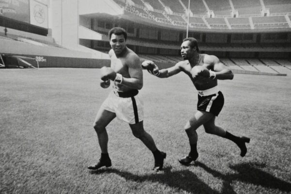 Two boxers training in a stadium.