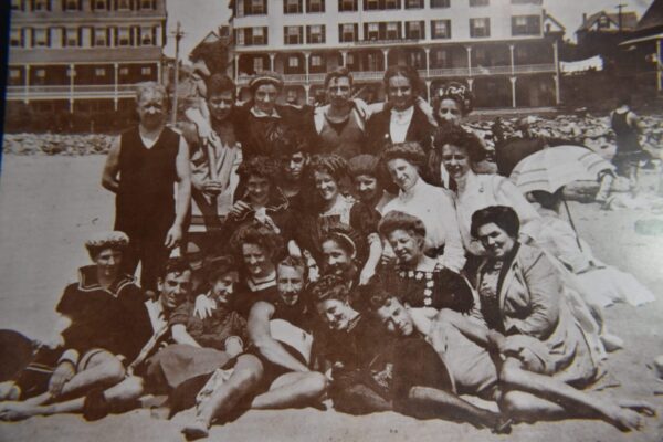 Group of people posing on a beach.